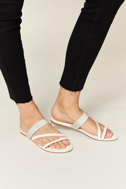 WILD DIVA Rhinestone Strappy Flat Sandals - White, worn on foot lifestyle shot - Be Juliet