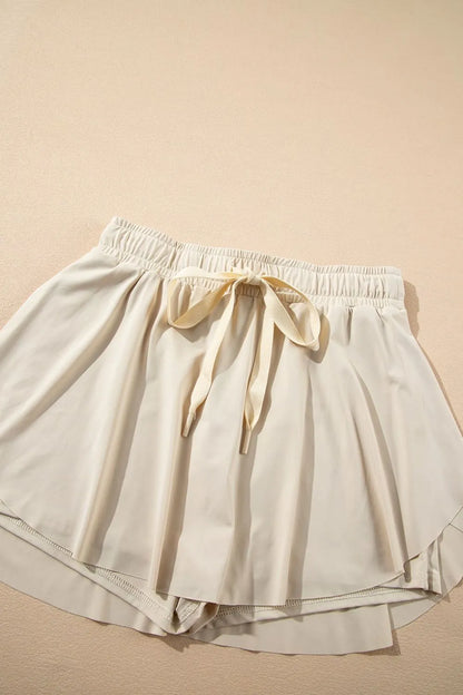 Romy Drawstring Active Skort - Light Blue, 3/4 angled view on model - Be Juliet