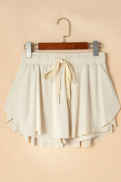 Romy Drawstring Active Skort - Beige, 3/4 angled view on model - Be Juliet