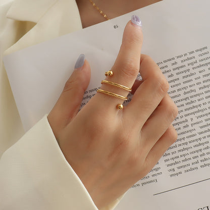 Titanium Steel Wrap Ring - Gold, front view on finger - Be Juliet