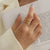 Titanium Steel Wrap Ring - Gold, front view on finger - Be Juliet