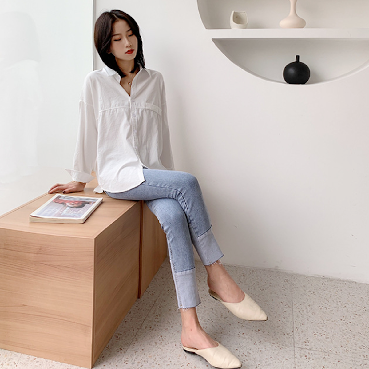 Womens Relaxed Fit Longline Shirt - seated side-angled view on model, curved hem and relaxed drape - Be Juliet