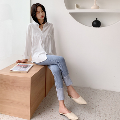 Womens Relaxed Fit Longline Shirt - seated side-angled view on model, curved hem and relaxed drape - Be Juliet