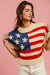 The Liberté — Star Patches American Flag Sleeveless Sweater - Vivid Red, front hem lift - Be Juliet